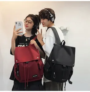 Detail of red and black waterproof nylon backpacks with flap and drawstring closure