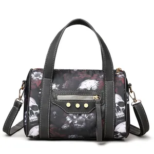 Close-up of gothic skull print handbag featuring metallic zippers and gold rivet details