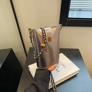 Petit sac seau argenté métallisé avec bandoulière chaîne et fermoir doré élégant