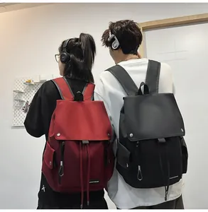 Back view of burgundy and black nylon backpacks featuring flap closure and drawstring design