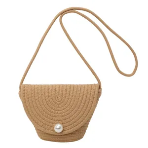 Fashionable straw bucket bag with spiral woven pattern and large pearl clasp detail