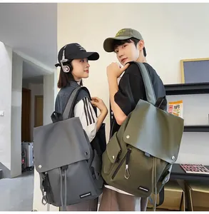 Detailed view of large-capacity nylon backpacks in grey and olive green worn by models