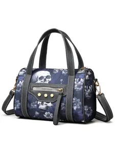 Close-up of gothic skull floral print handbag with golden studs and zipper detail