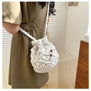 Detailed texture of white hand-woven drawstring bucket bag with wooden beads decoration