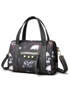 Detail view of gothic skull and floral print Boston bag with gold rivets and leather tassels