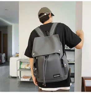 Detailed back view of a grey high-capacity nylon backpack with flap and drawstring