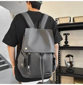 Close-up of gray waterproof high school backpack with stylish matte texture and black straps