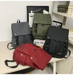 Detailed view of workwear style nylon backpacks in black, green, gray and burgundy colors