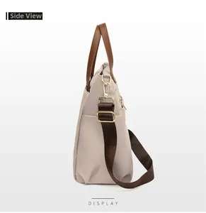 Side view of beige nylon laptop bag showing gold hardware and detachable shoulder strap