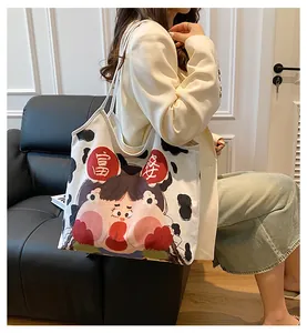 Lifestyle view of cream canvas tote bag with cow print edges and cute cartoon illustration