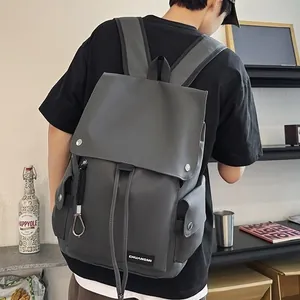 Deep grey waterproof minimalist backpack with flap cover and side pockets on male model