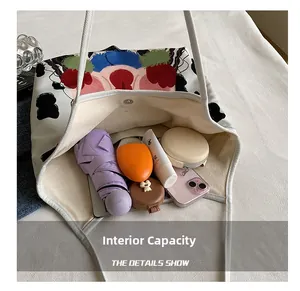 Internal capacity of white canvas tote bag with cow print and artistic cartoon portrait