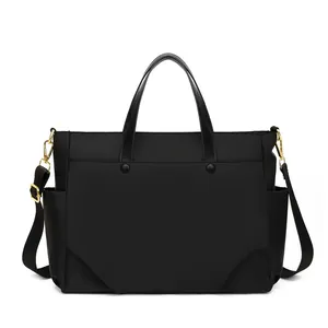 Details van 15,6 inch laptoptas van zwart nylon met gouden gespen en handige zijvakken
