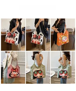 Lifestyle view of cute canvas tote bags with cartoon illustrations and shoulder straps