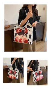 Detail of canvas tote bag featuring funny cartoon portrait and cow print accents