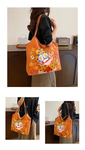 Detail of orange canvas tote bag with cute cartoon leopard print and Chinese characters