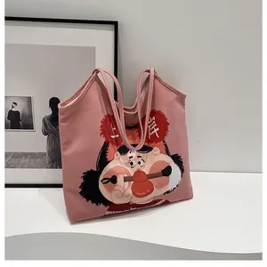 Detailed view of pink canvas tote bag featuring original 'Shang'an' cartoon illustration