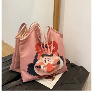 Detail of cute pink canvas tote bag with original artistic cartoon character illustration