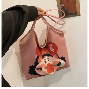 Pink canvas tote bag featuring unique cartoon character print and durable shoulder straps