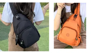 Outdoor close-up of nylon crossbody chest bags in black and orange with adjustable straps
