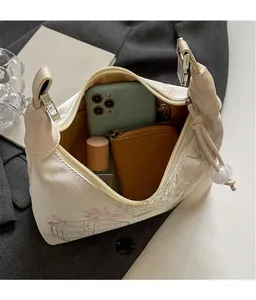 Internal view of beige floral crossbody bag showing space for phone and wallet