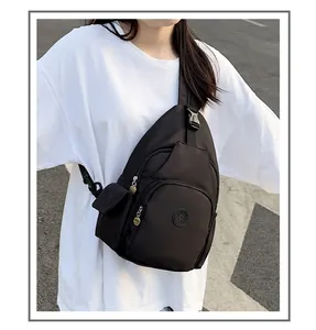 Close-up of waterproof nylon crossbody bag showing adjustable buckle and multi-pocket layout