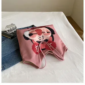 Detailed view of pink canvas tote bag featuring Lotso bear print and lucky charms text