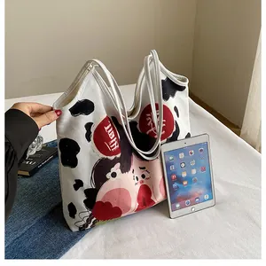 Canvas tote bag with cute cow print and girl illustration showing inner storage capacity