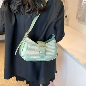 Detail showing the woven texture and premium leather stitching on this green shoulder bag