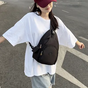 Versatile black nylon crossbody sports sling bag with adjustable strap and multi-pockets