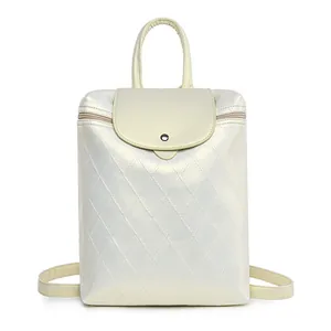Detail of quilted leather backpack in pearl white with metallic finish and top handle