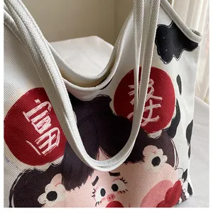 Close-up of canvas tote bag featuring cartoon girl illustration and cow print accents