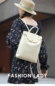 Detail view of cream white quilted leather backpack with elegant diamond pattern stitching