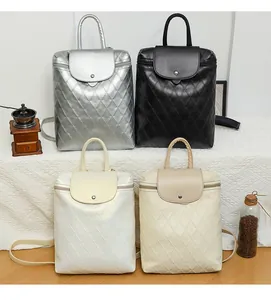 Detailed view of women's quilted backpacks in silver, black, white, and beige colors