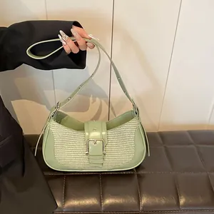 Detail of mint green leather and woven fabric shoulder bag with silver buckle accent