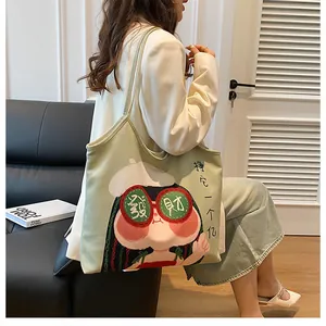 Detail of light green canvas tote bag featuring original girl cartoon with lucky symbols