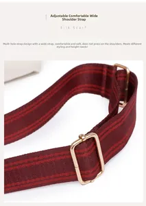 Close-up of a burgundy striped wide canvas strap with gold adjustable metal buckle