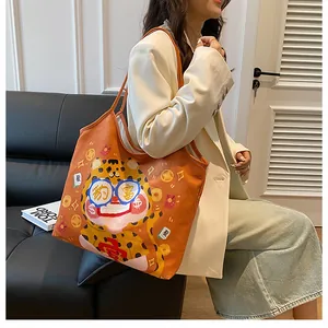 Detail of orange canvas tote bag with cartoon leopard print and Chinese cultural motifs
