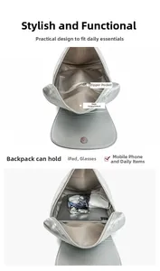Interior view of silver quilted backpack showing large capacity and zipper pockets