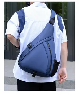 Detail of dark blue triangular chest bag featuring water-resistant nylon and mesh pocket
