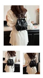 Detailed views of a black glossy drawstring bucket backpack with adjustable straps
