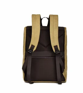 Detail view of the breathable mesh back and trolley strap on the canvas backpack
