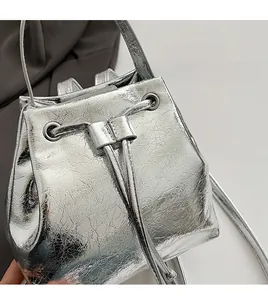 Detail of silver crackle texture bucket bag with drawstring and metal eyelets