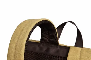 Detail view of thickened canvas handle and breathable mesh shoulder straps on backpack