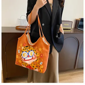 Detail of cute orange canvas tote bag with cartoon leopard and lucky charm patterns