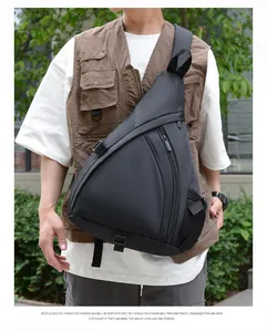 Close-up of black waterproof nylon chest bag featuring adjustable strap and side mesh pocket