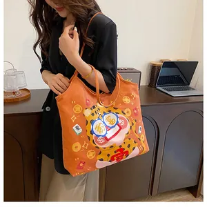 Detailed close-up of a large orange canvas tote bag with festive cartoon tiger illustrations
