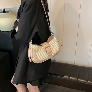 Detailed shot of the chic woven leather shoulder bag showing texture and metal buckle