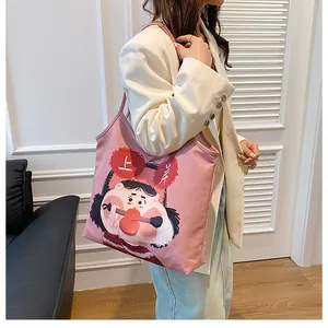 Pink canvas tote bag featuring original cartoon graphics and comfortable shoulder strap
