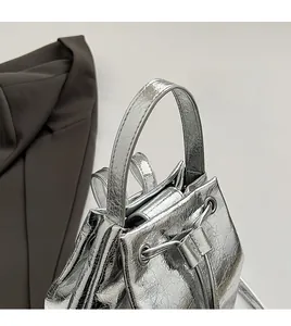 Close-up of comfortable handle and silver metallic crackle texture on bucket bag